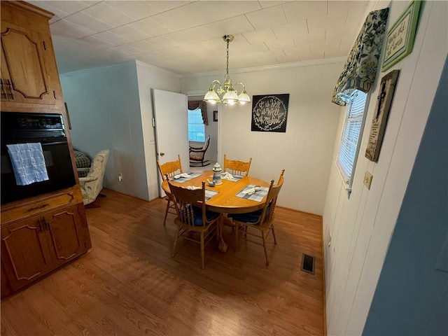 308 Oak Drive Ext, Honea Path, SC 29654 - dining area featuring a chandelier, light wood-style flooring, and crown molding