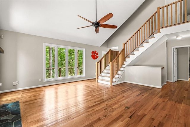 307 Warbranch Rd, Central, SC 29630 - unfurnished living room with ceiling fan, stairs, high vaulted ceiling, wood finished floors, and baseboards