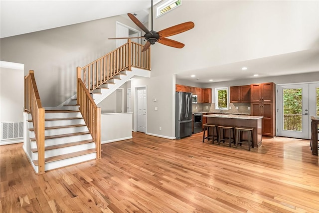307 Warbranch Rd, Central, SC 29630 - living room with light wood-style flooring, high vaulted ceiling, stairs, ceiling fan, and baseboards