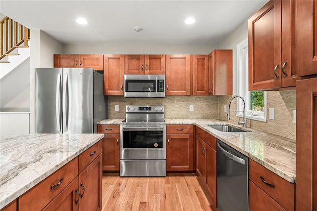 307 Warbranch Rd, Central, SC 29630 - kitchen with appliances with stainless steel finishes, a sink, light wood-type flooring, light stone countertops, and recessed lighting