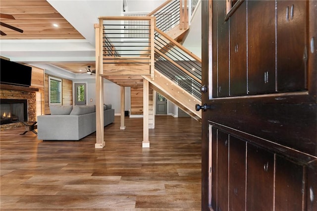 2000 Ridge Rd, Hartwell, GA 30643 - staircase featuring ceiling fan, wood finished floors, a stone fireplace, recessed lighting, and baseboards