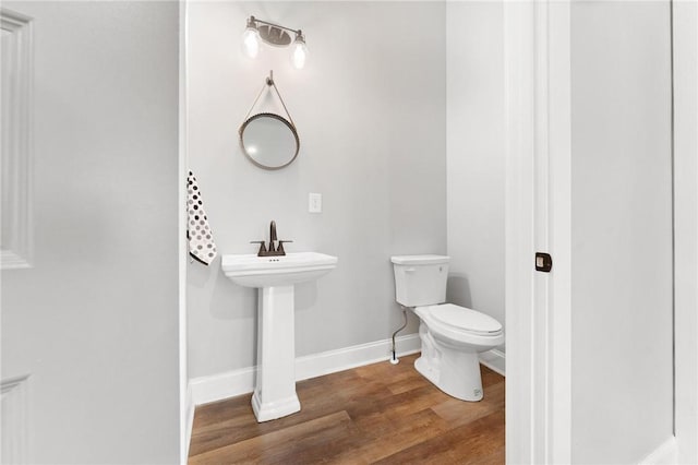 2000 Ridge Rd, Hartwell, GA 30643 - half bathroom featuring toilet, wood finished floors, and baseboards