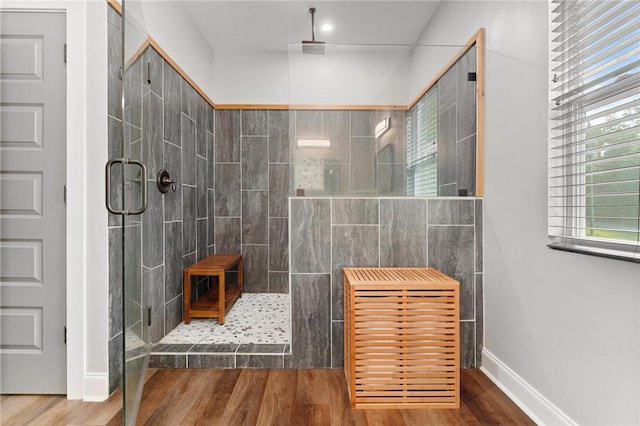 2000 Ridge Rd, Hartwell, GA 30643 - full bathroom with a tile shower, wood finished floors, and baseboards