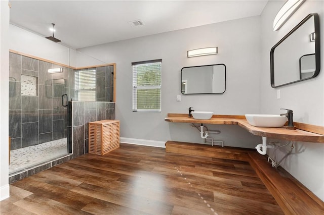 2000 Ridge Rd, Hartwell, GA 30643 - full bath featuring wood finished floors, a stall shower, baseboards, and a sink