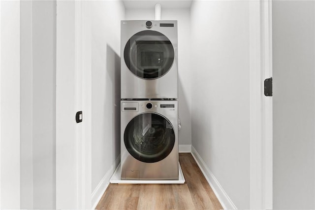 2000 Ridge Rd, Hartwell, GA 30643 - laundry area with stacked washer / drying machine, wood finished floors, and baseboards