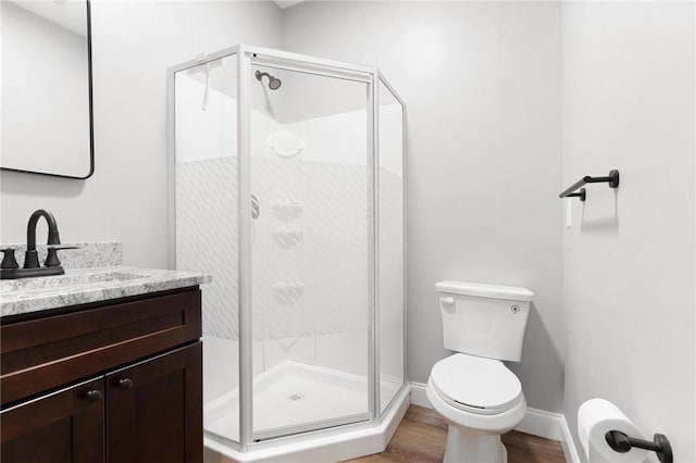 2000 Ridge Rd, Hartwell, GA 30643 - full bathroom with toilet, vanity, a shower stall, wood finished floors, and baseboards