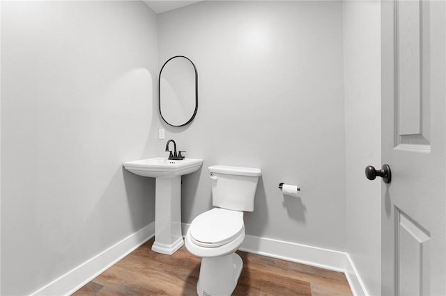 2000 Ridge Rd, Hartwell, GA 30643 - bathroom with toilet, baseboards, and wood finished floors