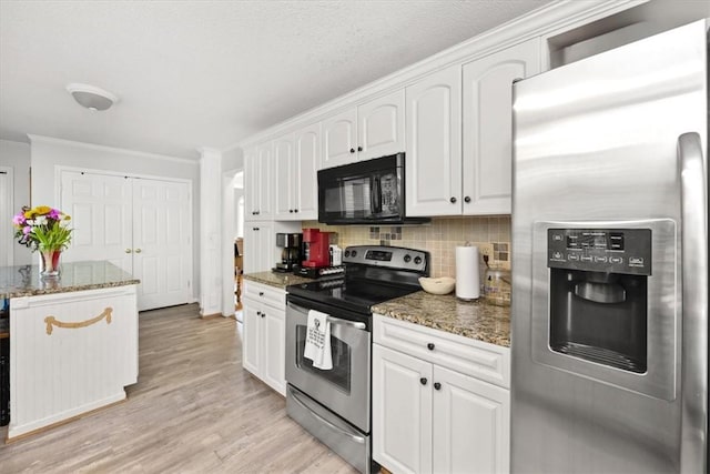 151 Hannah Cir, Anderson, SC 29621 - kitchen with appliances with stainless steel finishes, white cabinets, decorative backsplash, light wood-style flooring, and dark stone counters