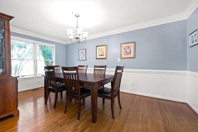 151 Hannah Cir, Anderson, SC 29621 - dining room with a chandelier, wood finished floors, crown molding, and baseboards