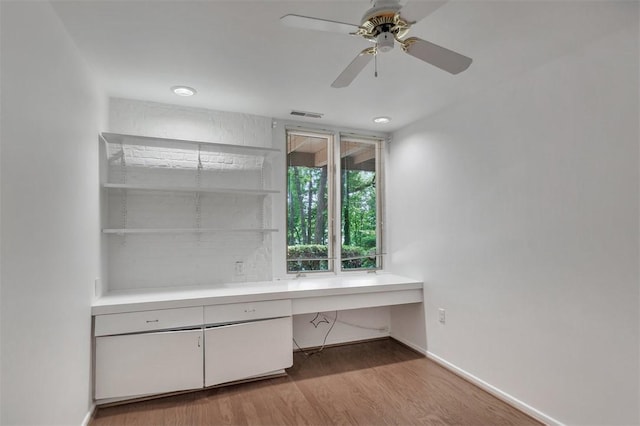1613 S Arlington Dr, Seneca, SC 29672 - unfurnished office with wood finished floors, a ceiling fan, baseboards, and built in desk