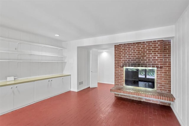 1613 S Arlington Dr, Seneca, SC 29672 - unfurnished living room featuring a brick fireplace and wood finished floors