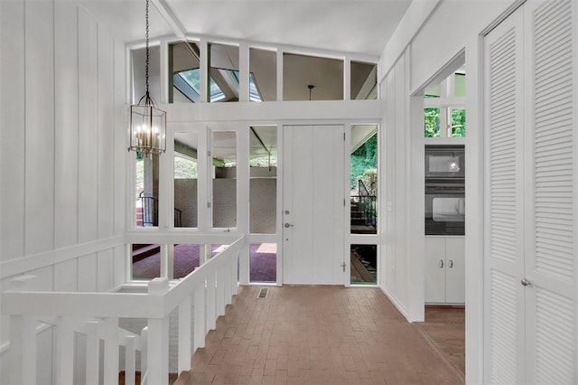 1613 S Arlington Dr, Seneca, SC 29672 - entrance foyer with brick floors and a chandelier