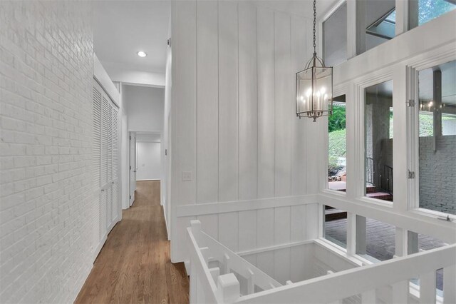 1613 S Arlington Dr, Seneca, SC 29672 - corridor with brick wall, wood finished floors, and a chandelier