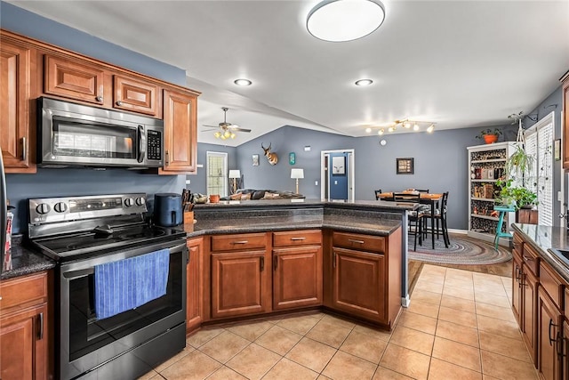 169 Campbell Bridge Rd, Seneca, SC 29678 - kitchen with stainless steel appliances, a peninsula, light tile patterned flooring, brown cabinets, and ceiling fan