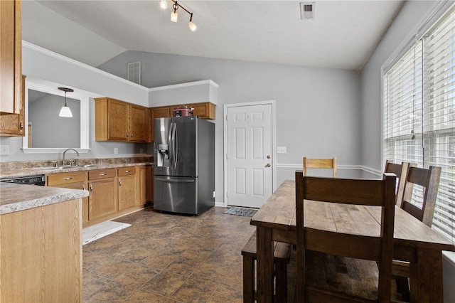 15 Laws Ln, Piedmont, SC 29673 - kitchen with stainless steel fridge, vaulted ceiling, brown cabinetry, hanging light fixtures, and light countertops