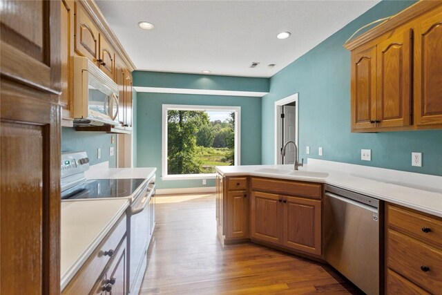 204 Lakeside Dr, Walhalla, SC 29691 - kitchen with white appliances, a sink, wood finished floors, a peninsula, and brown cabinetry
