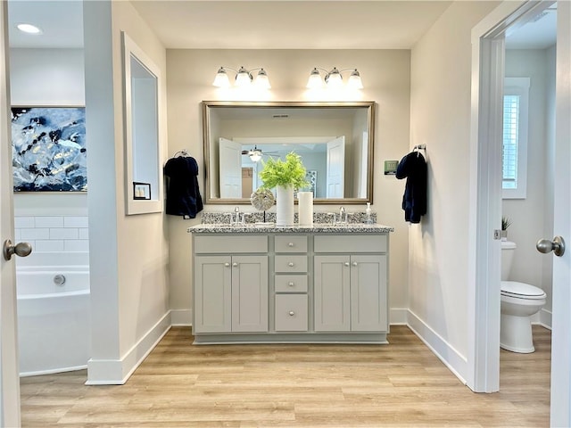 448 Seaborn Cir, Pendleton, SC 29670 - bathroom featuring double vanity, toilet, wood finished floors, and baseboards