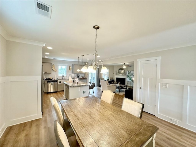 448 Seaborn Cir, Pendleton, SC 29670 - dining area featuring light wood-style floors, a chandelier, a wainscoted wall, recessed lighting, and ornamental molding