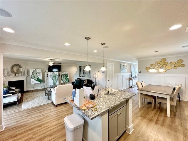 448 Seaborn Cir, Pendleton, SC 29670 - kitchen featuring open floor plan, gray cabinets, light wood-style flooring, ornamental molding, and wainscoting