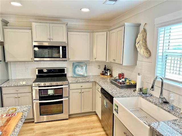 448 Seaborn Cir, Pendleton, SC 29670 - kitchen featuring appliances with stainless steel finishes, a sink, tasteful backsplash, light stone counters, and recessed lighting