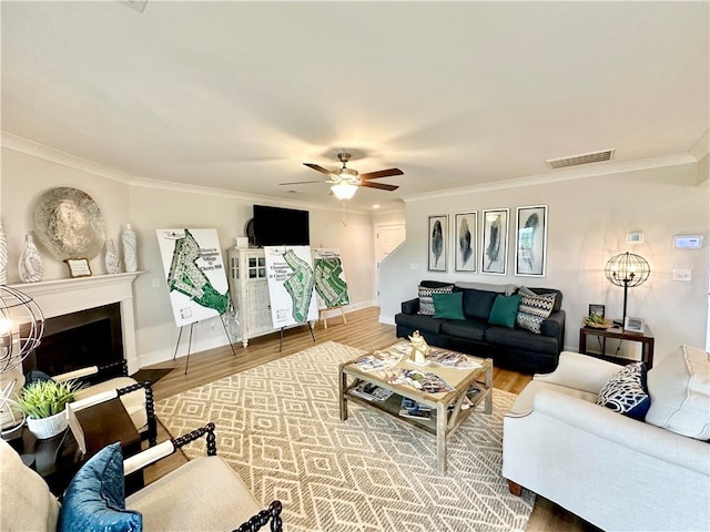 448 Seaborn Cir, Pendleton, SC 29670 - living area with crown molding, ceiling fan, wood finished floors, a fireplace, and baseboards