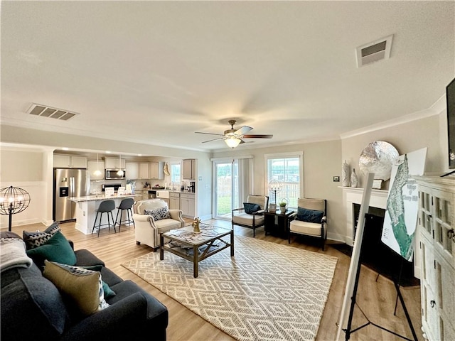 448 Seaborn Cir, Pendleton, SC 29670 - living room with crown molding, ceiling fan, light wood-style floors, and baseboards