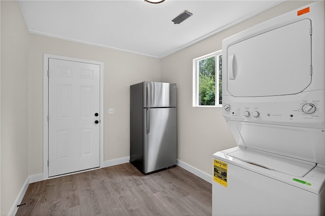 1103 Scott Dr, Anderson, SC 29625 - laundry room with stacked washer and clothes dryer and wood finished floors