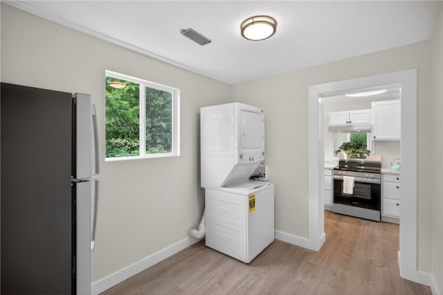1103 Scott Dr, Anderson, SC 29625 - laundry area with stacked washing machine and dryer and light wood-type flooring