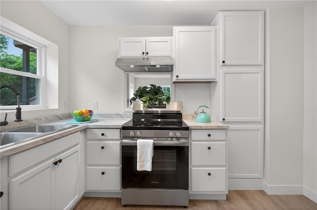 1103 Scott Dr, Anderson, SC 29625 - kitchen featuring stainless steel electric range, under cabinet range hood, white cabinetry, light wood-style floors, and light countertops