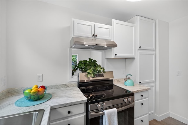 1103 Scott Dr, Anderson, SC 29625 - kitchen featuring stainless steel electric range, under cabinet range hood, white cabinets, and wood finished floors