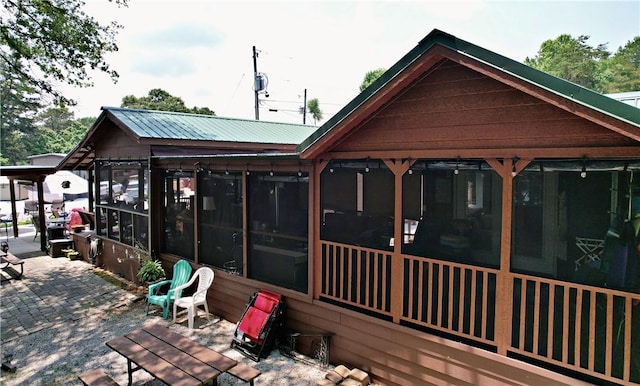 669 N Fleetwood Ln, Fair Play, SC 29643 - rear view of property featuring a sunroom, metal roof, and a patio