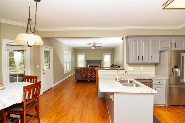 104 Tinsley Dr, Anderson, SC 29621 - kitchen with stainless steel fridge with ice dispenser, a sink, a peninsula, gray cabinets, and ornamental molding
