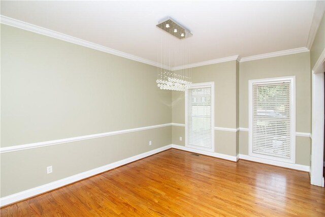 104 Tinsley Dr, Anderson, SC 29621 - unfurnished dining area with a chandelier, light wood finished floors, baseboards, and crown molding