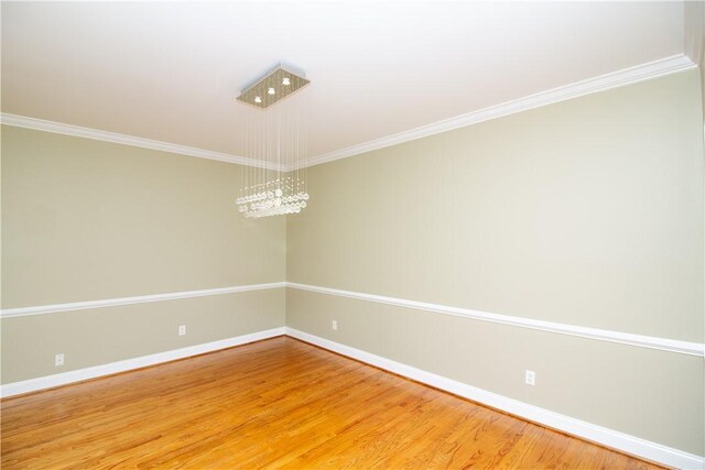 104 Tinsley Dr, Anderson, SC 29621 - spare room with baseboards, crown molding, light wood-style flooring, and a chandelier