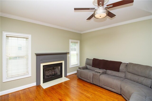 104 Tinsley Dr, Anderson, SC 29621 - living area featuring crown molding, ceiling fan, baseboards, wood finished floors, and a fireplace with flush hearth