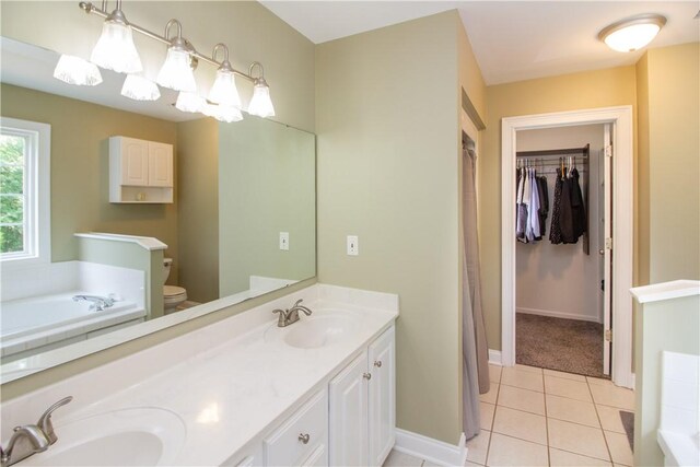 104 Tinsley Dr, Anderson, SC 29621 - bathroom featuring a bath, double vanity, tile patterned flooring, baseboards, and toilet