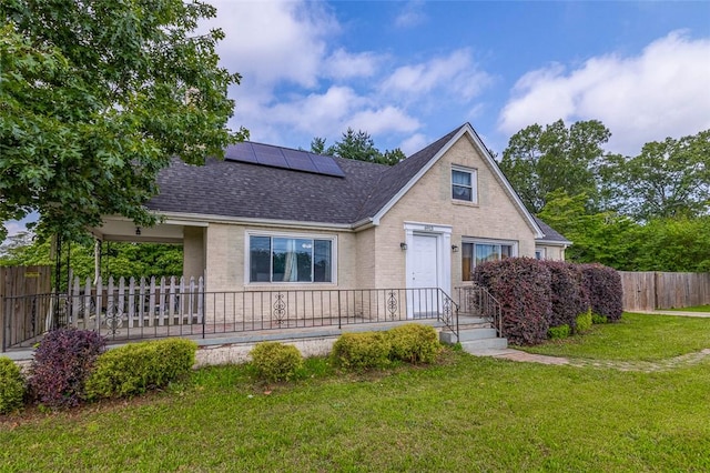 6913 White Horse Rd, Greenville, SC 29611 - view of front of home with roof with shingles, roof mounted solar panels, and brick siding