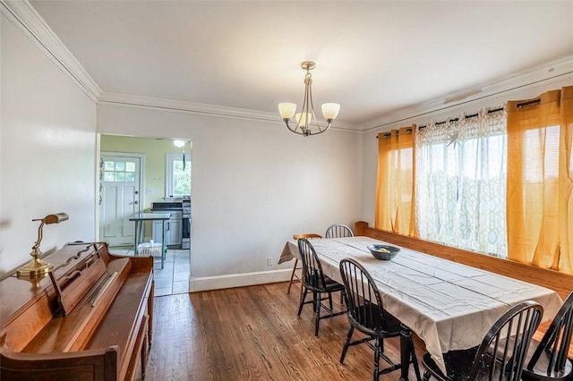 6913 White Horse Rd, Greenville, SC 29611 - dining space with ornamental molding, a chandelier, dark wood finished floors, and baseboards
