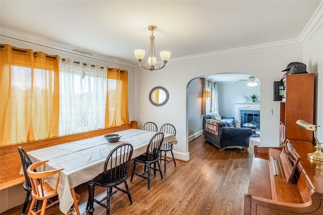 6913 White Horse Rd, Greenville, SC 29611 - dining area with arched walkways, healthy amount of natural light, a tiled fireplace, ornamental molding, and wood finished floors