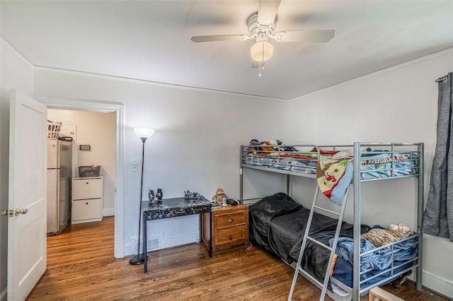 6913 White Horse Rd, Greenville, SC 29611 - bedroom with wood finished floors, freestanding refrigerator, and ceiling fan