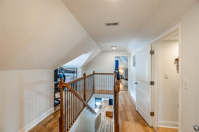 6913 White Horse Rd, Greenville, SC 29611 - hallway featuring an upstairs landing, light wood-style floors, baseboards, and vaulted ceiling