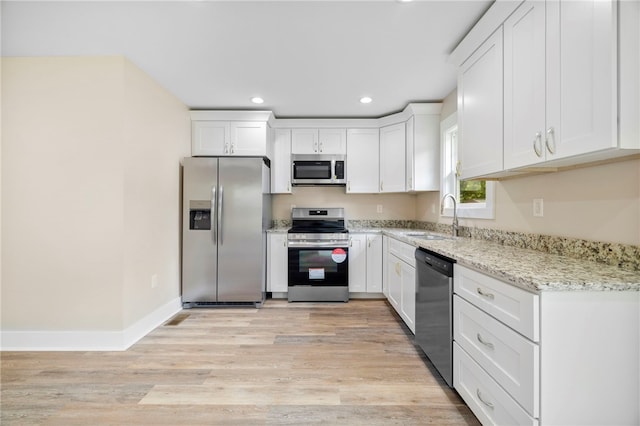 1205 W Franklin St, Anderson, SC 29624 - kitchen featuring appliances with stainless steel finishes, a sink, recessed lighting, white cabinetry, and light stone counters