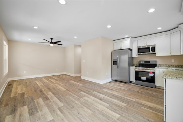 1205 W Franklin St, Anderson, SC 29624 - kitchen with stainless steel appliances, a ceiling fan, light wood finished floors, light stone countertops, and recessed lighting