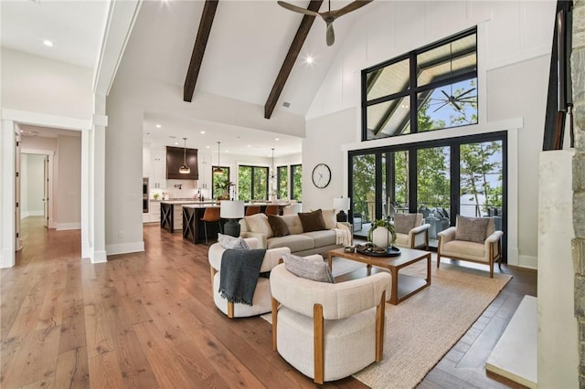 221 Hermitage Dr, Six Mile, SC 29682 - living area with high vaulted ceiling, light wood-style floors, a ceiling fan, beam ceiling, and baseboards