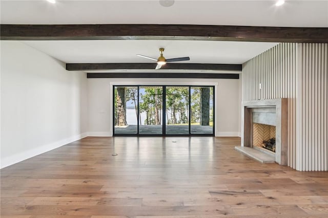 221 Hermitage Dr, Six Mile, SC 29682 - unfurnished living room featuring beam ceiling, a fireplace, baseboards, wood finished floors, and ceiling fan