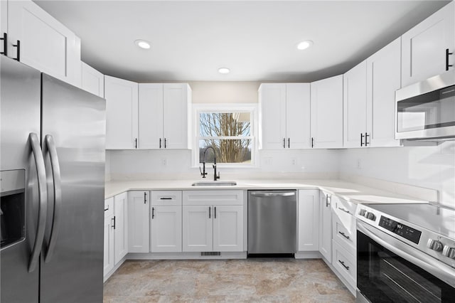 509 Old Clemson Hwy, Seneca, SC 29672 - kitchen with stainless steel appliances, a sink, white cabinets, light countertops, and recessed lighting