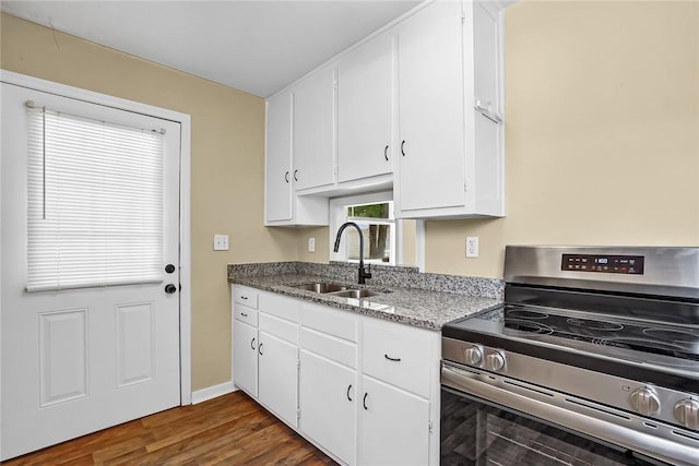710 Greenville St, Pendleton, SC 29670 - kitchen featuring electric stove, a sink, white cabinets, dark wood-type flooring, and light stone counters