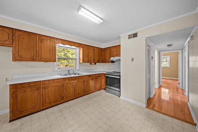100 Colonial Ct, West Union, SC 29696 - kitchen featuring stainless steel range, a sink, brown cabinets, light floors, and crown molding