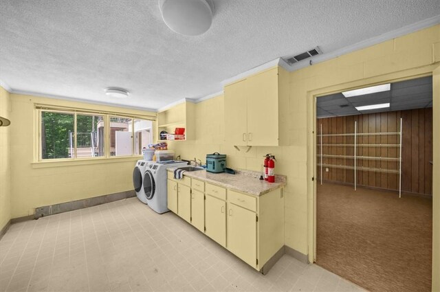 333 Woodland Way, Clemson, SC 29631 - laundry area with cabinet space, separate washer and dryer, a textured ceiling, and crown molding