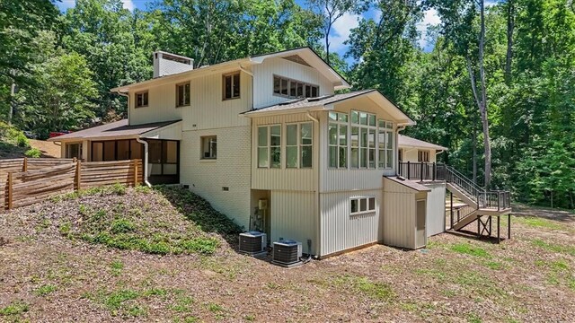 333 Woodland Way, Clemson, SC 29631 - back of property featuring a sunroom, stairway, a chimney, and brick siding